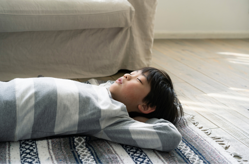 寝転ぶ子どもと絨毯
